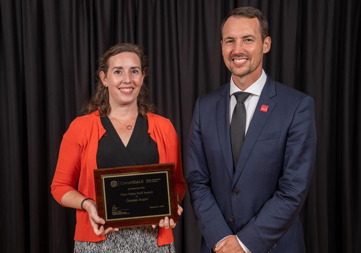 Canaan Boyer accepts a plaque from Cornell CALS Dean Ben Houlton