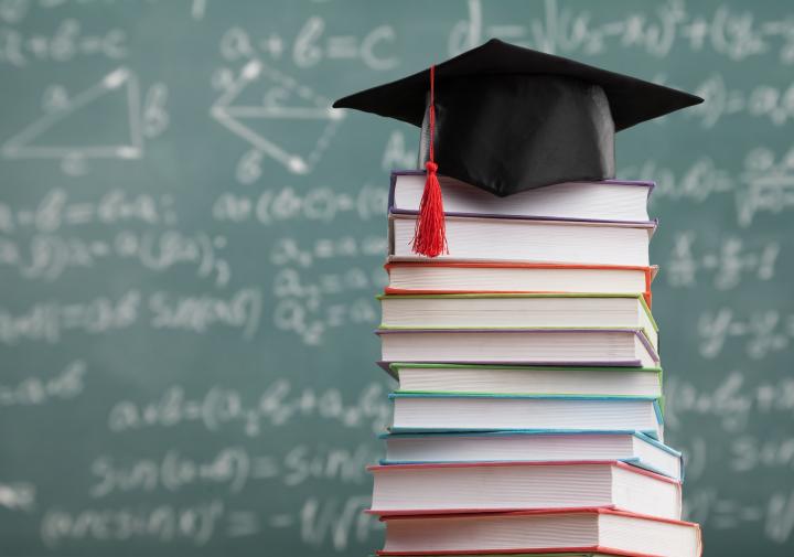 Image of books and graduate school cap