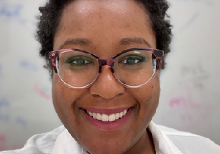 woman in lab coat with glasses