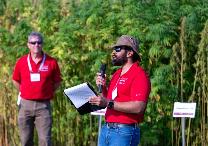 agritech scientists speak in front of hemp research plot