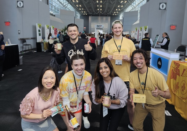 A group of people posing together in a large room