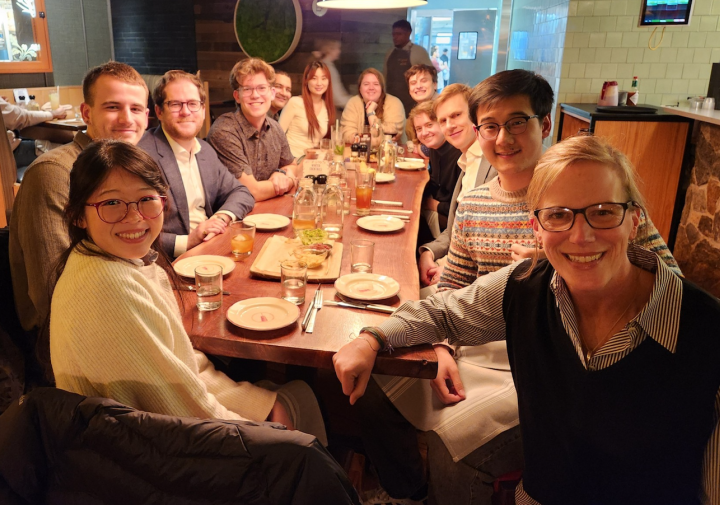 group sits around the dinner table