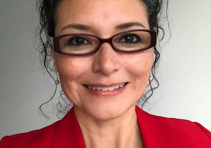 Portrait of a person wearing a red jacket and glasses.