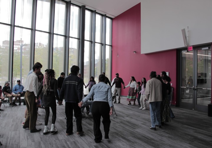 People hold hands in a circle.