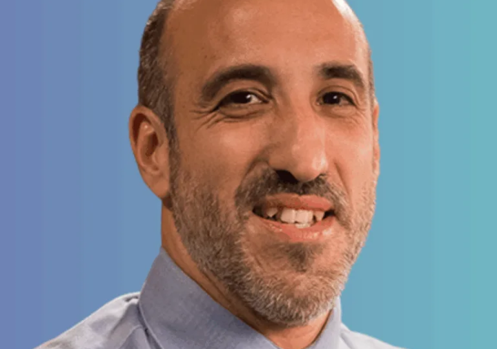 Professional portrait of aerson wearing a collared shirt and tie.