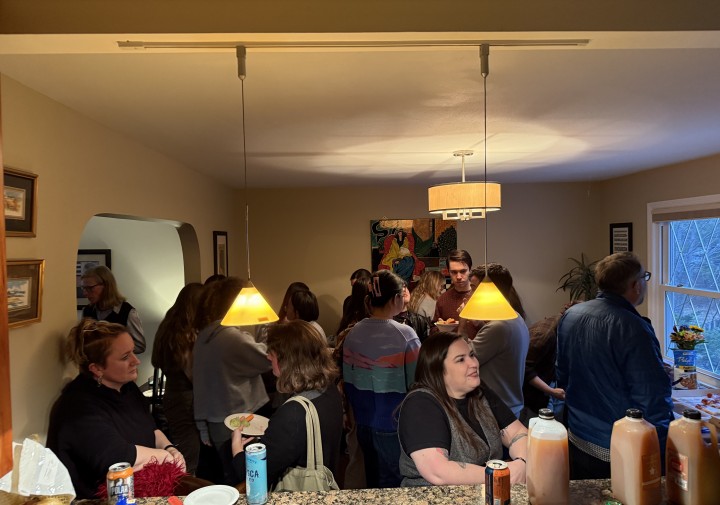 individuals engage in small group discussion in kitchen