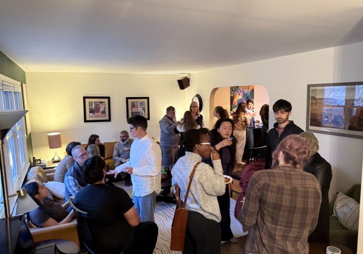individuals engage in group discussion in living room