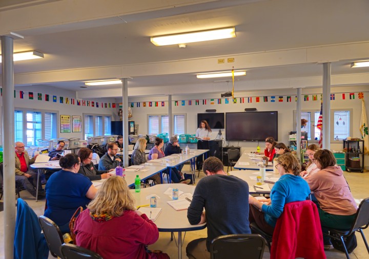 A group of people gathered in a class room. 