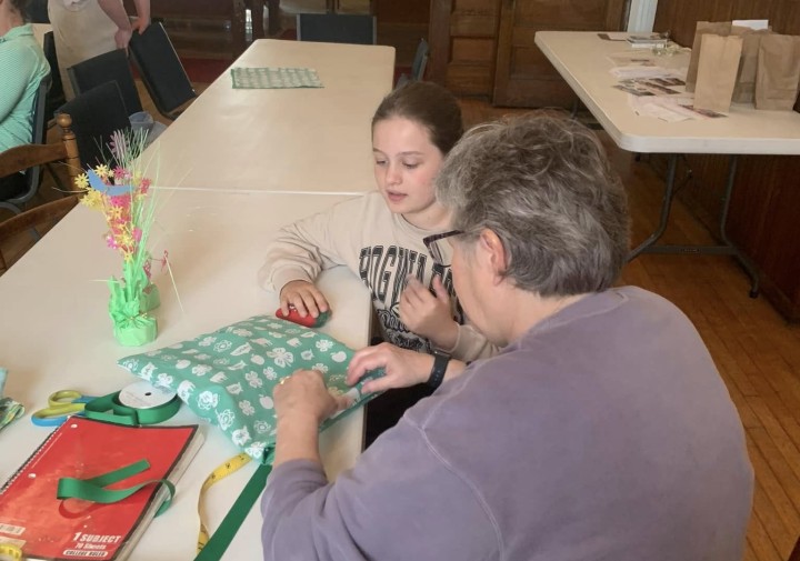 Linda teaching sewing basics to a 4-H youth. 