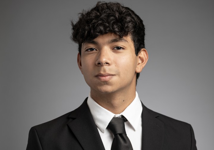 Smiling man in black suit & tie