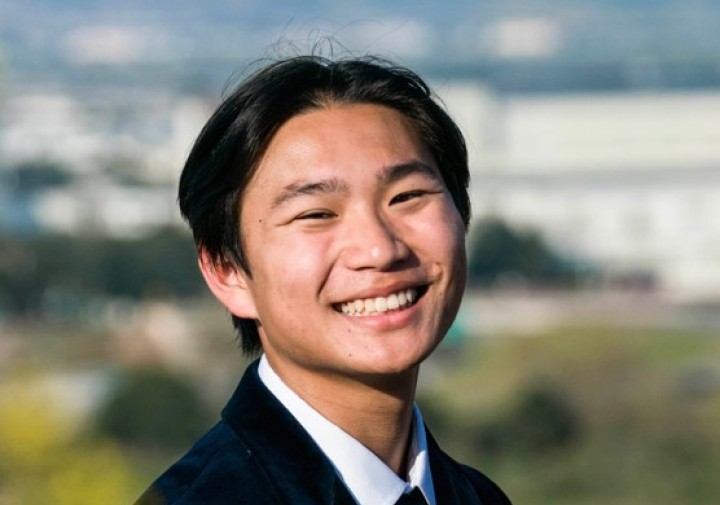 Smiling man in black suit