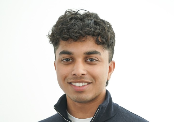 Man wearing dark sweater with collar popped up