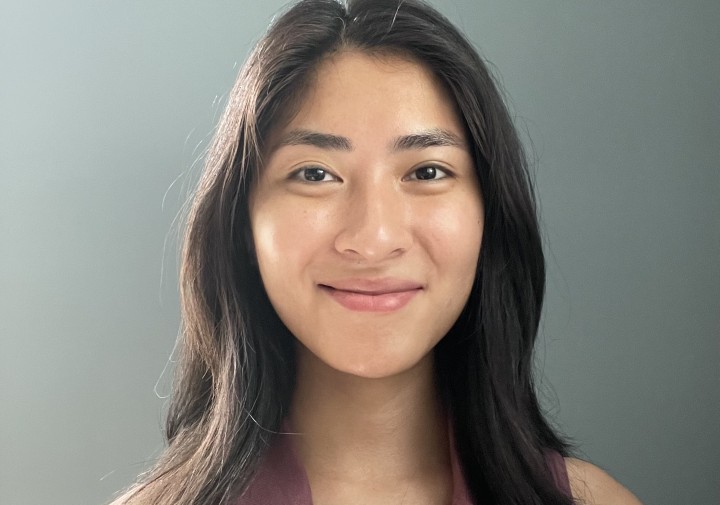 Smiling woman with maroon tank with collar