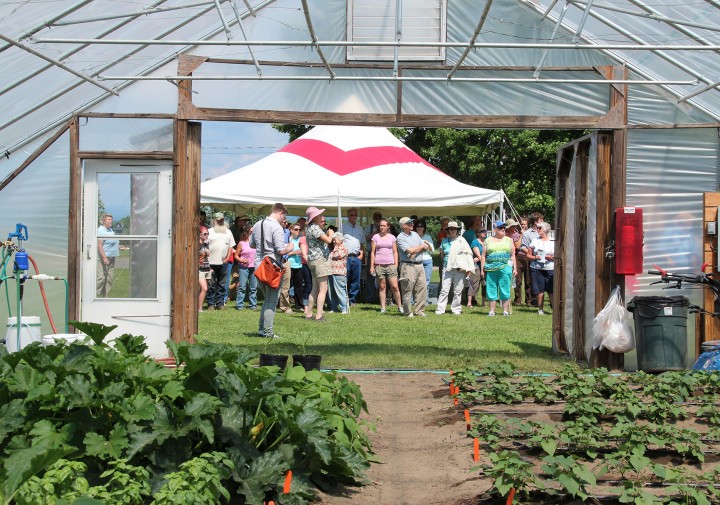 High tunnel, event tent, and a group of people