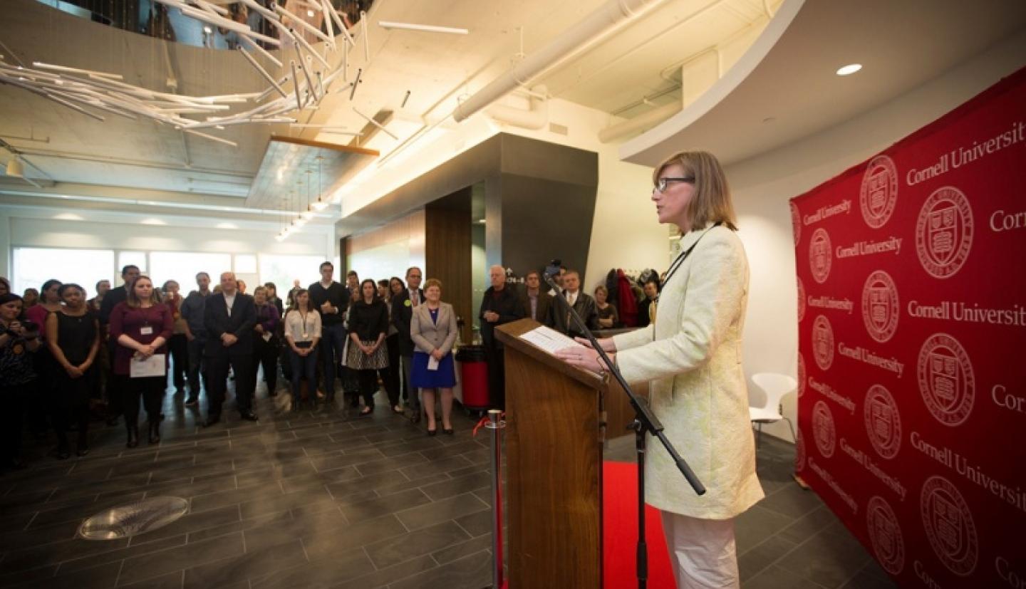 McComas speaking at podium