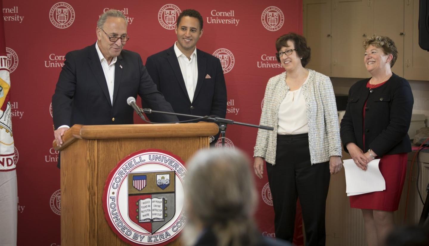 Senator Schumer addresses a crowd as President Pollack looks on