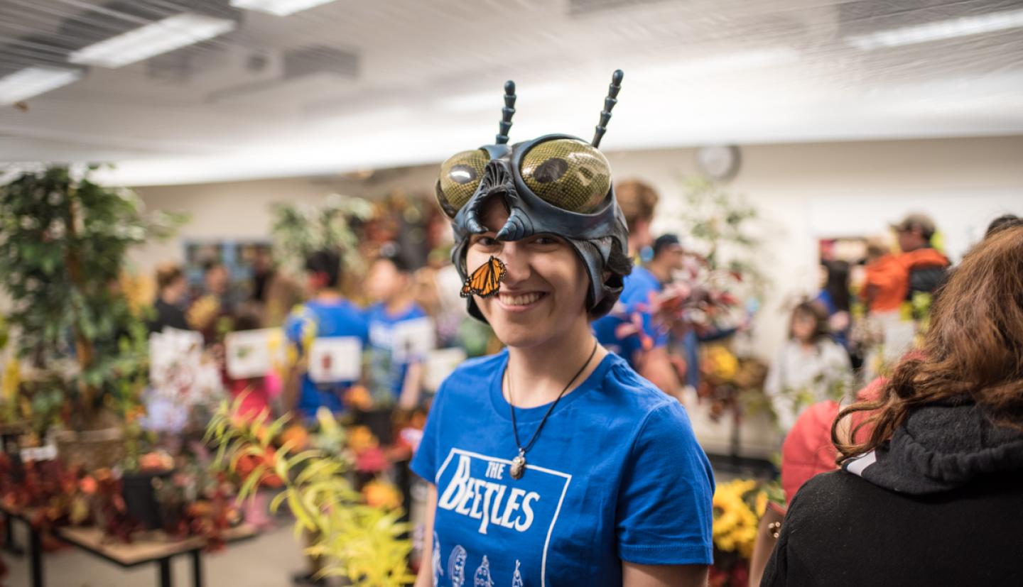 Student with bug hat and butterfly on her nose