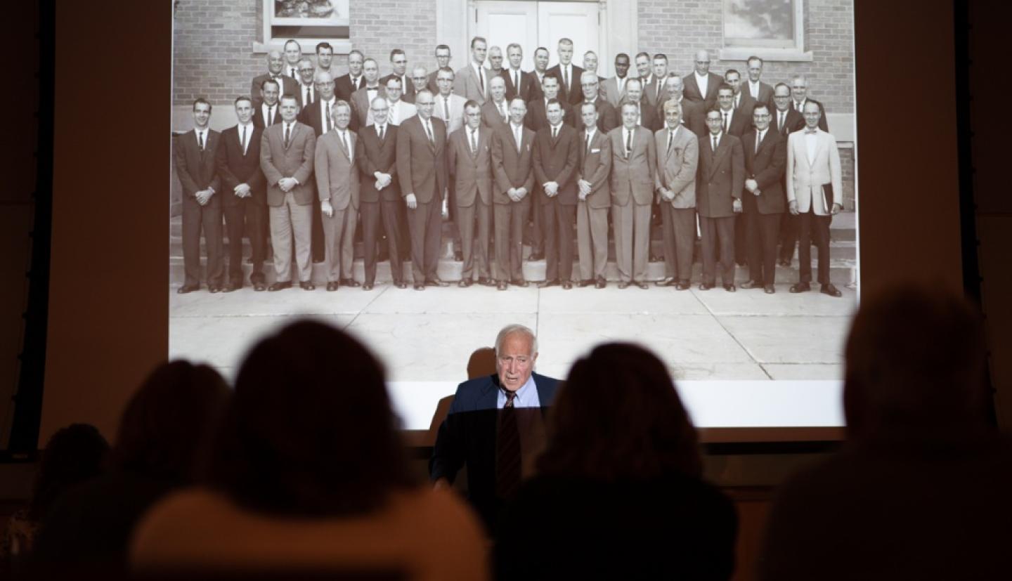 Bandler in foront of an image of the first Milk Inspectors Program