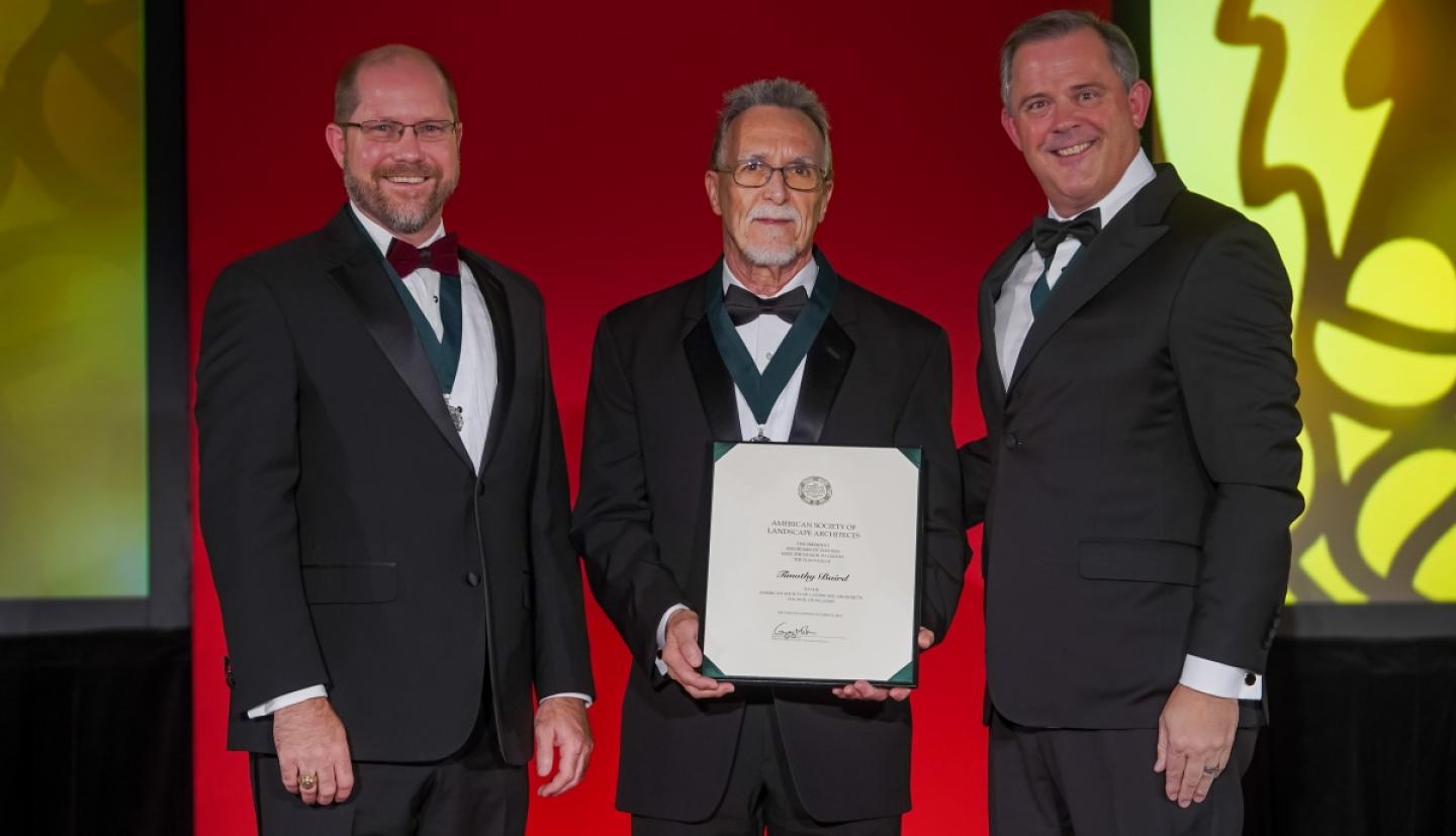 Baird on stage accepting award