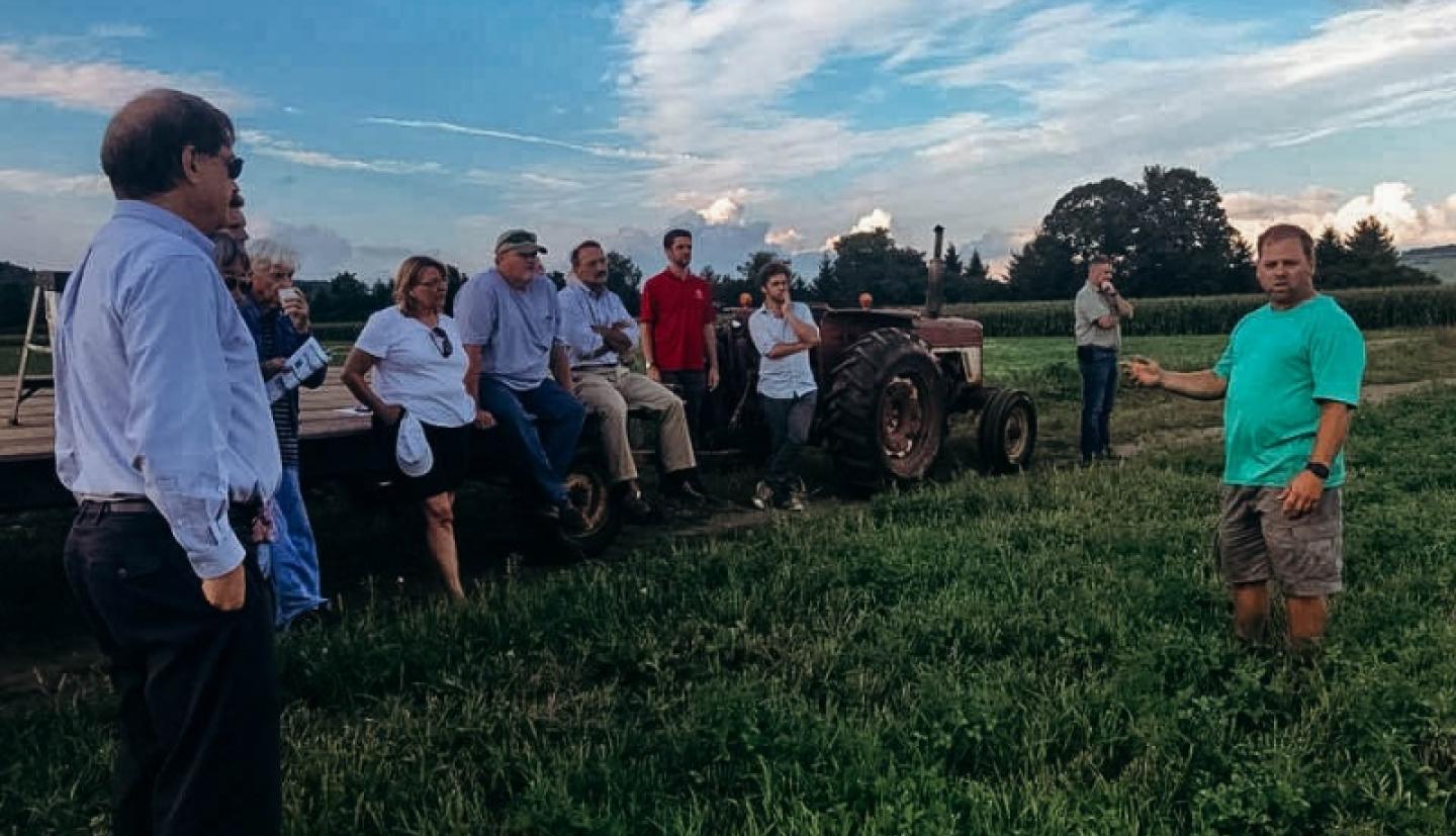 Corey Mosher speaking to farmers in field