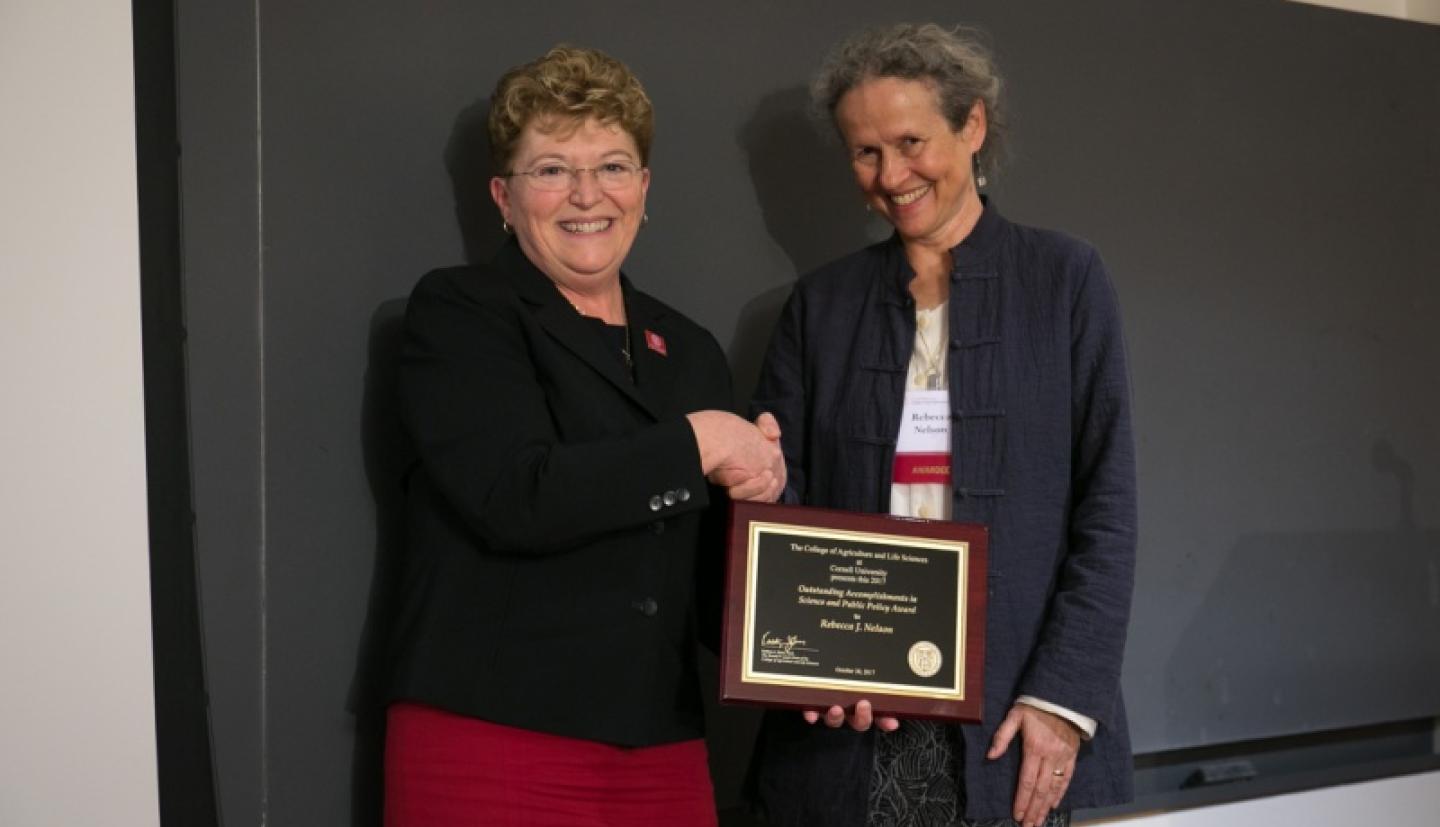 Dean Boor shaking hands with Rebecca Nelson