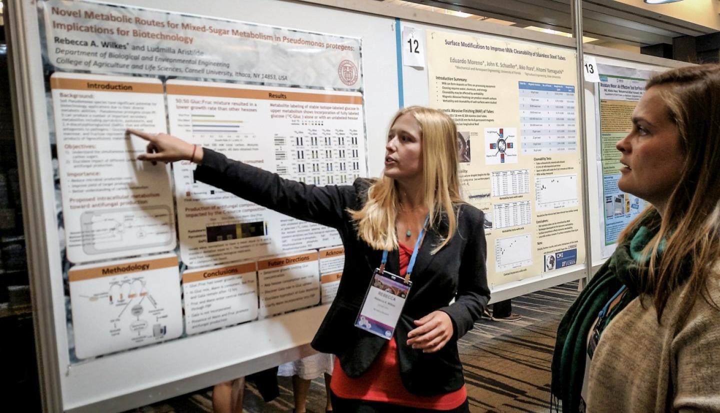 Student gives a poster presentation