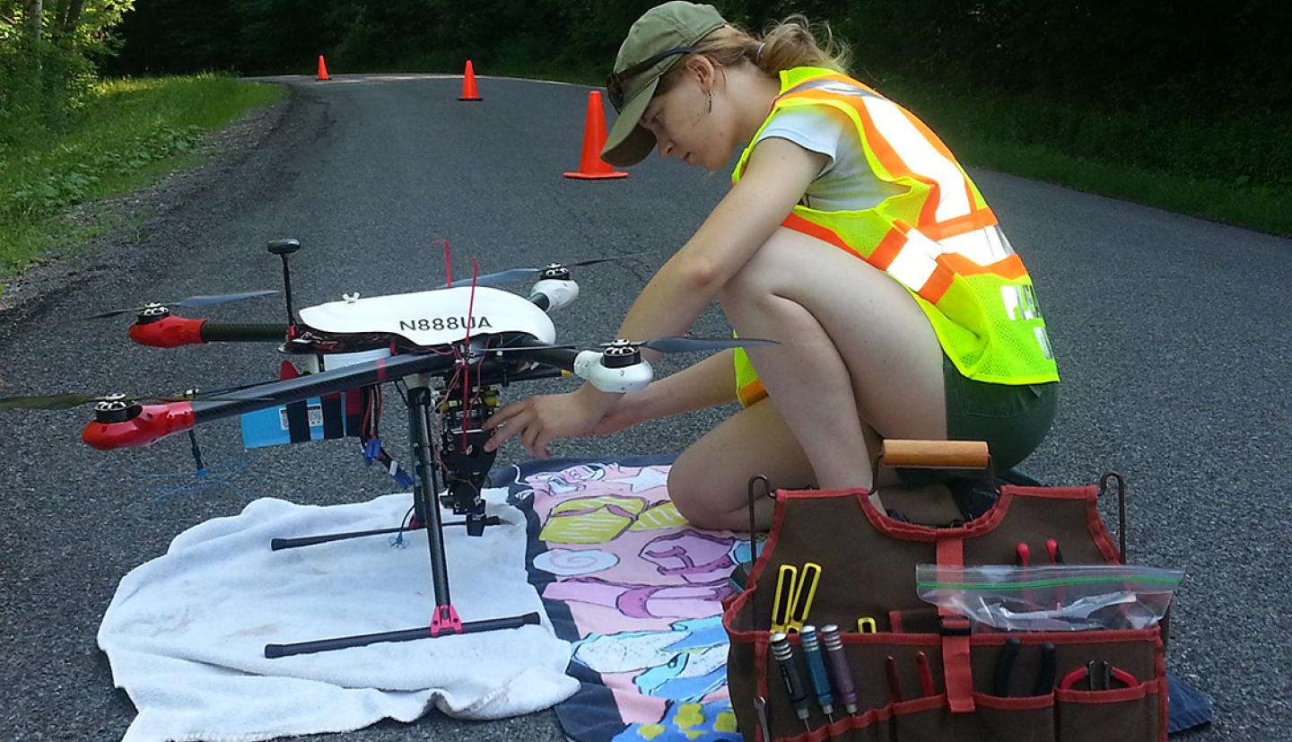 Student works with drone