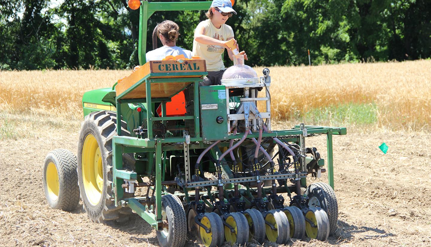 Researchers ride on a tractor