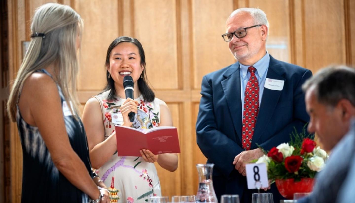 Student, Professor, and High School teacher present at luncheon
