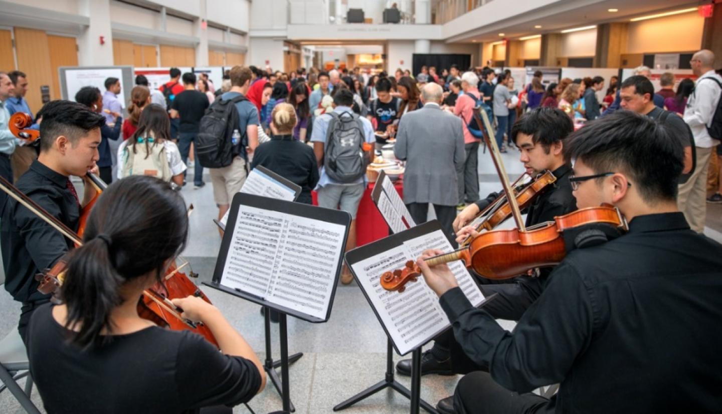 Students play string instruments