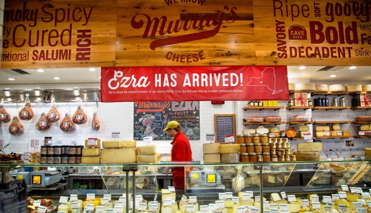 Cheese market with a sign that says "Ezra Has Arrived"