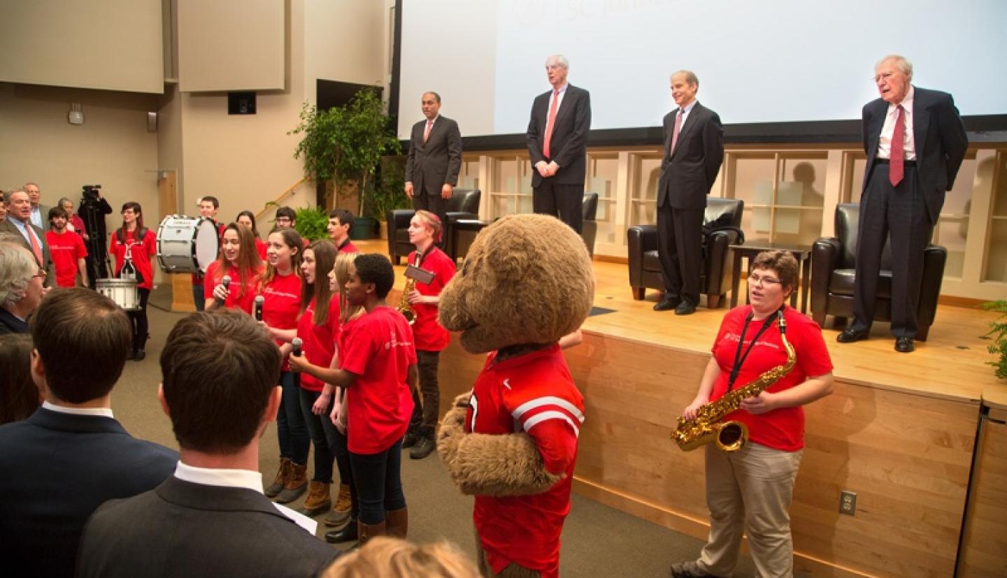 Band members playing in front of presentation