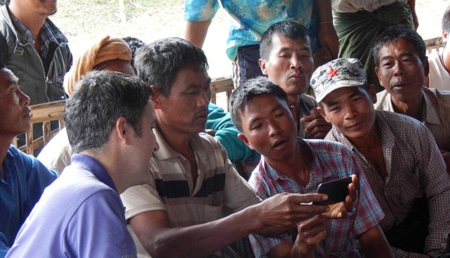 Farmers looking at phone