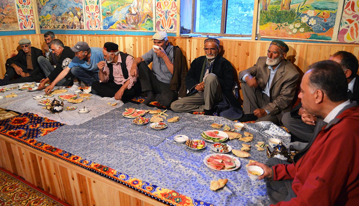 Researchers and villagers seated around a table