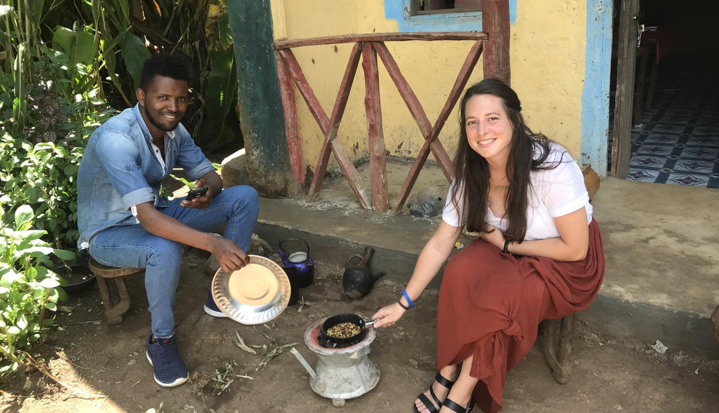 Man and woman sit and prepare food