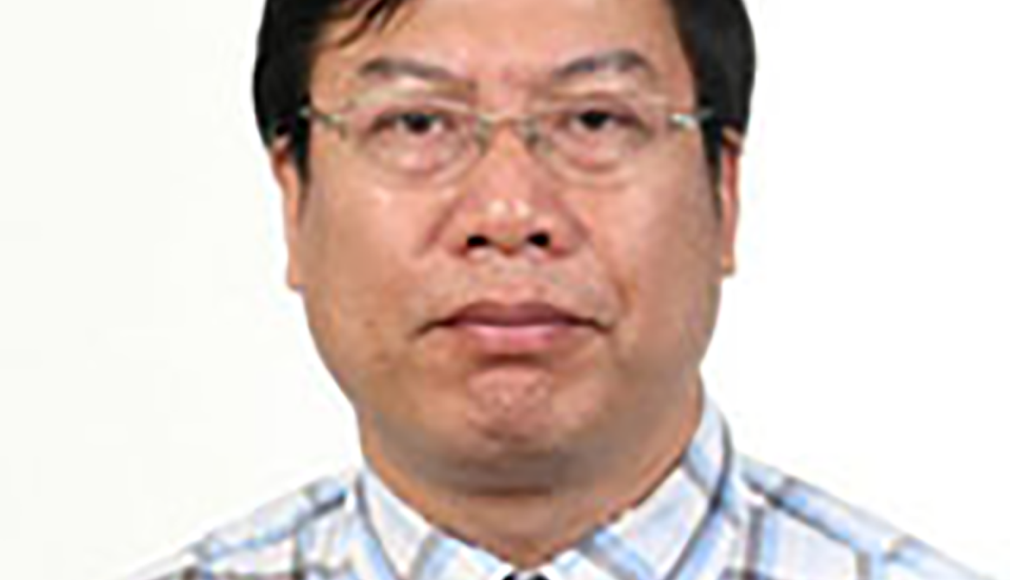 a man in a checkered shirt and glasses