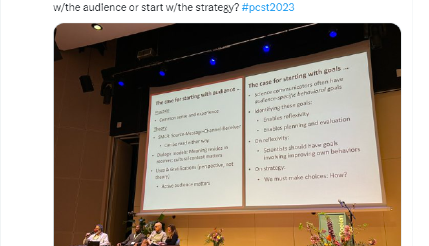 panel of individuals in front of big screen in lecture hall