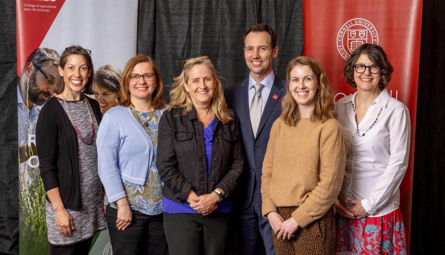 6 individuals standing and smiling