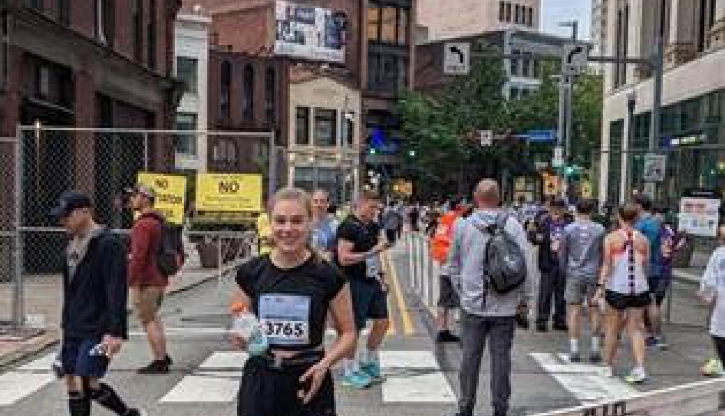 women standing on road after finishing marathon