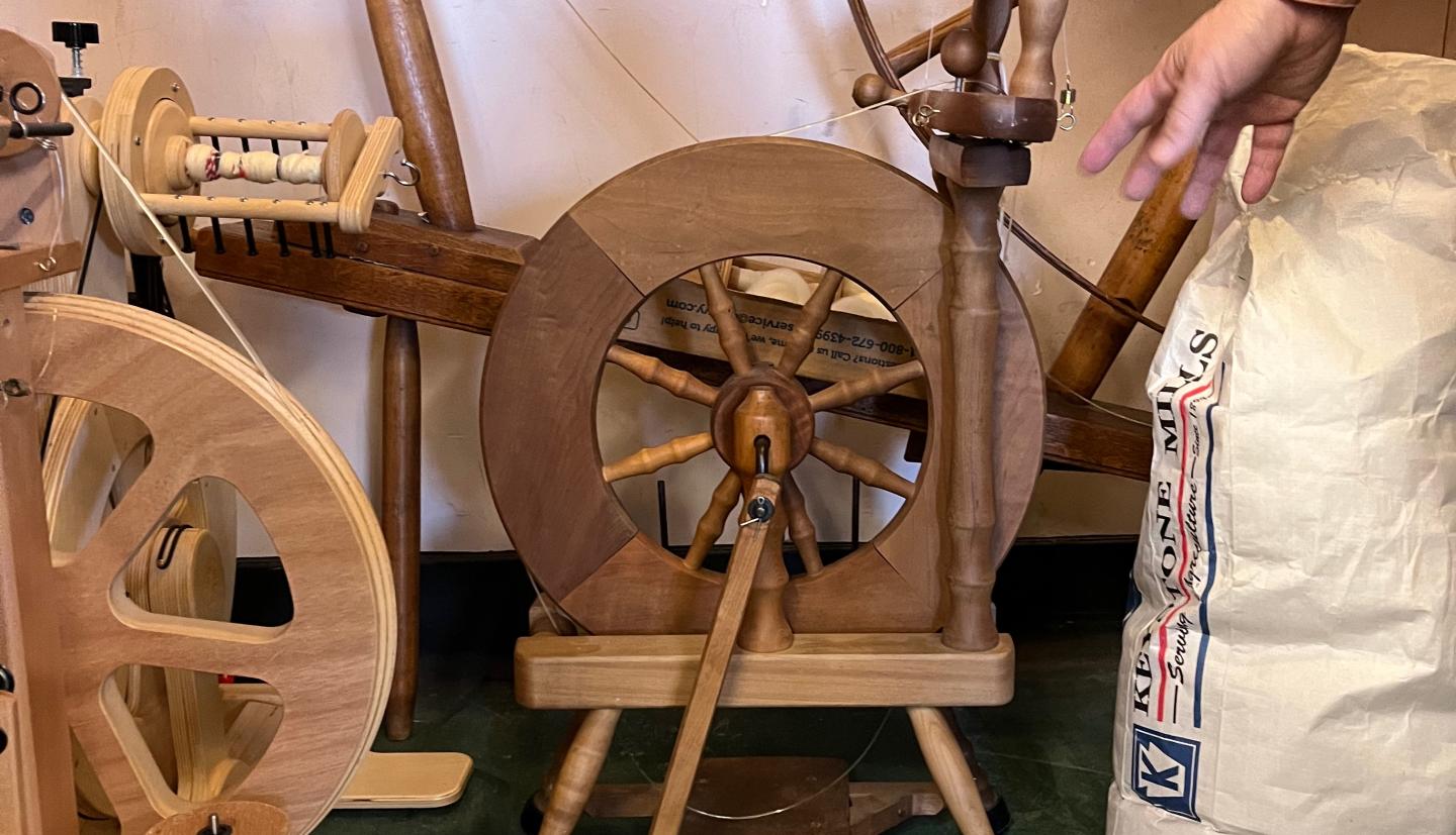 spinning wheels fill the corner of a room