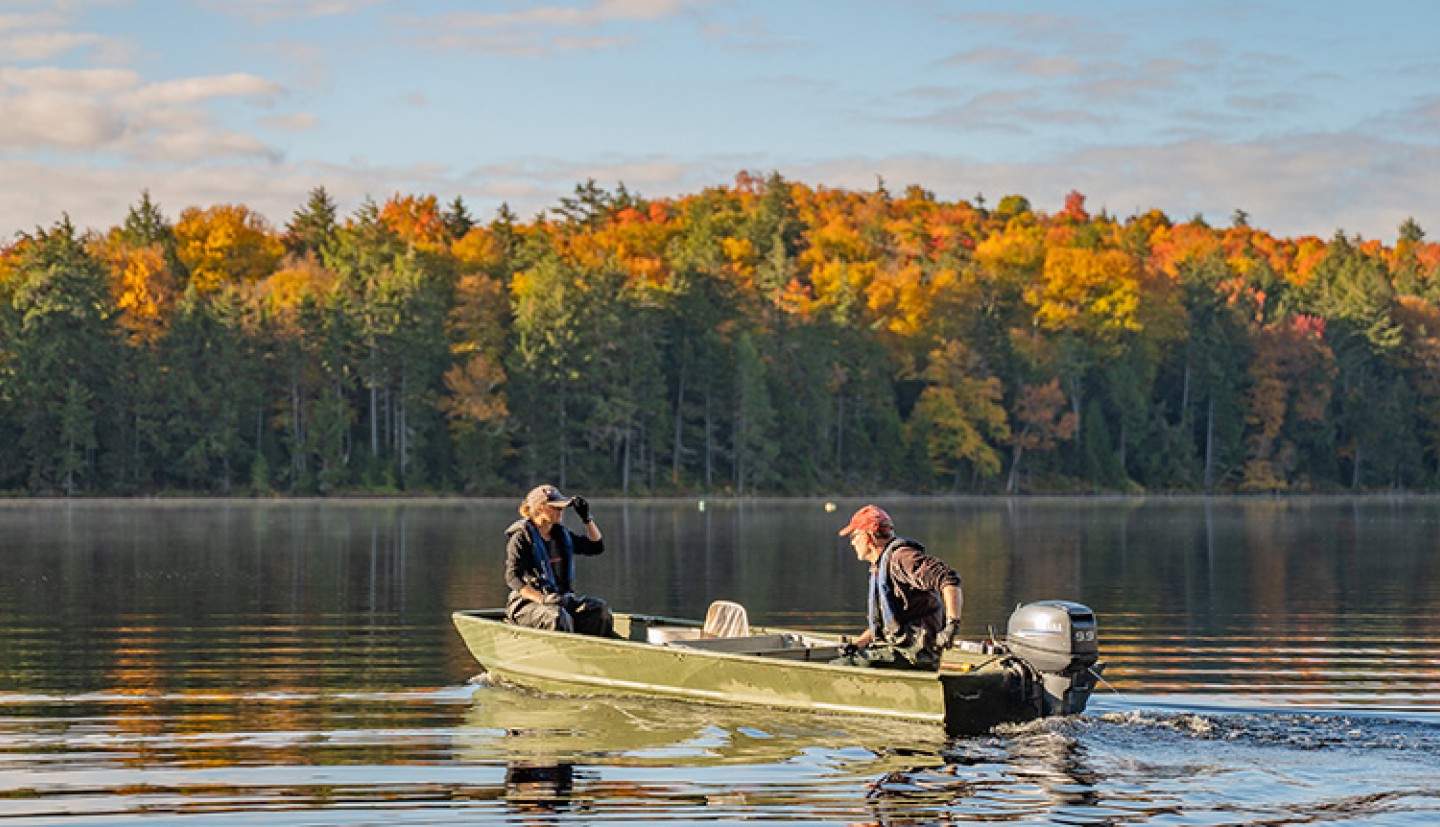 Two people fishing on a lake.