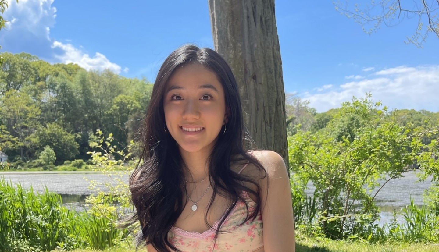 Girl sitting on a blanket on the grass