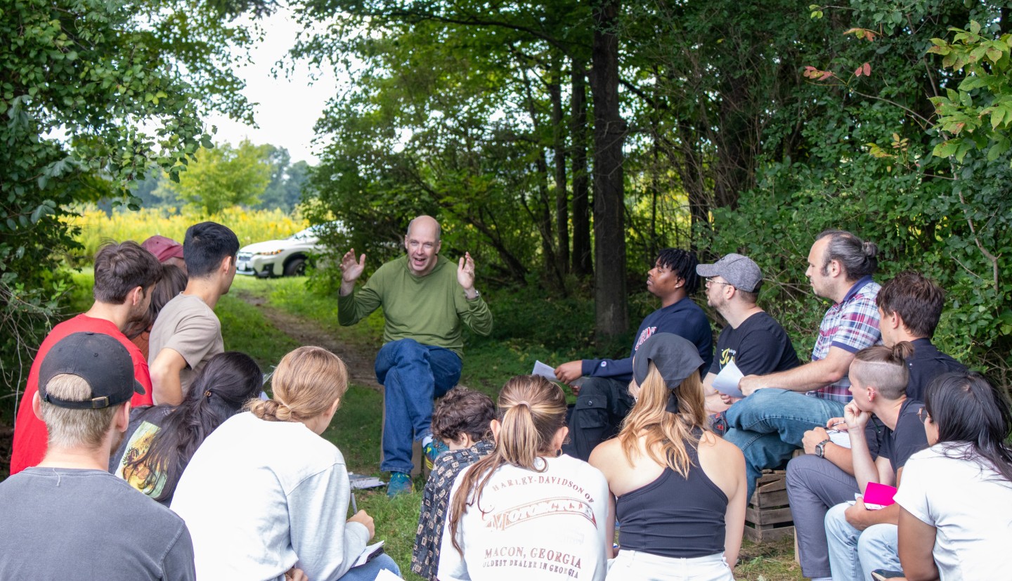 A group of people on the edge of a forest