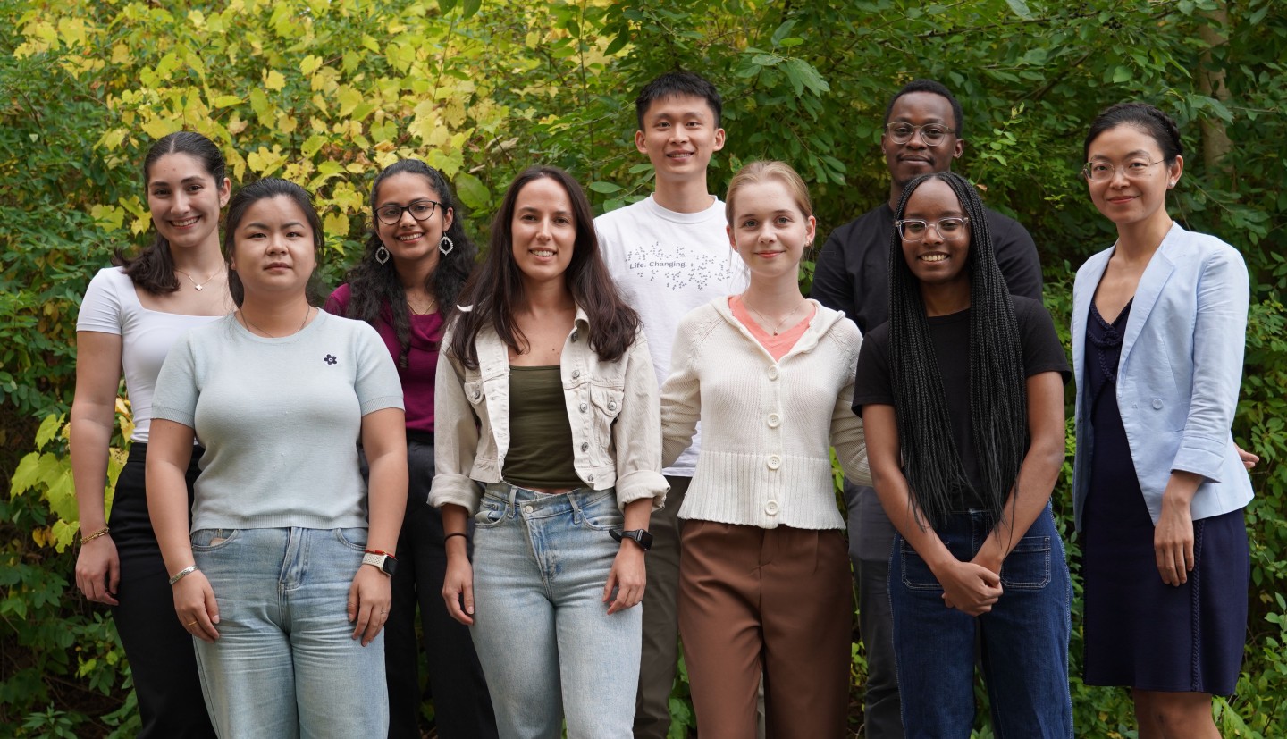 a group of people stand together outside