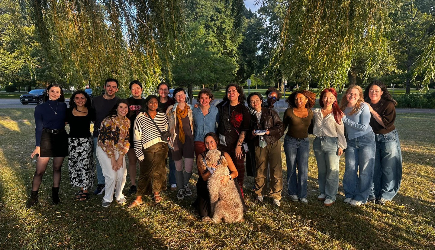 Comm Grad students gather for a photo in the a park