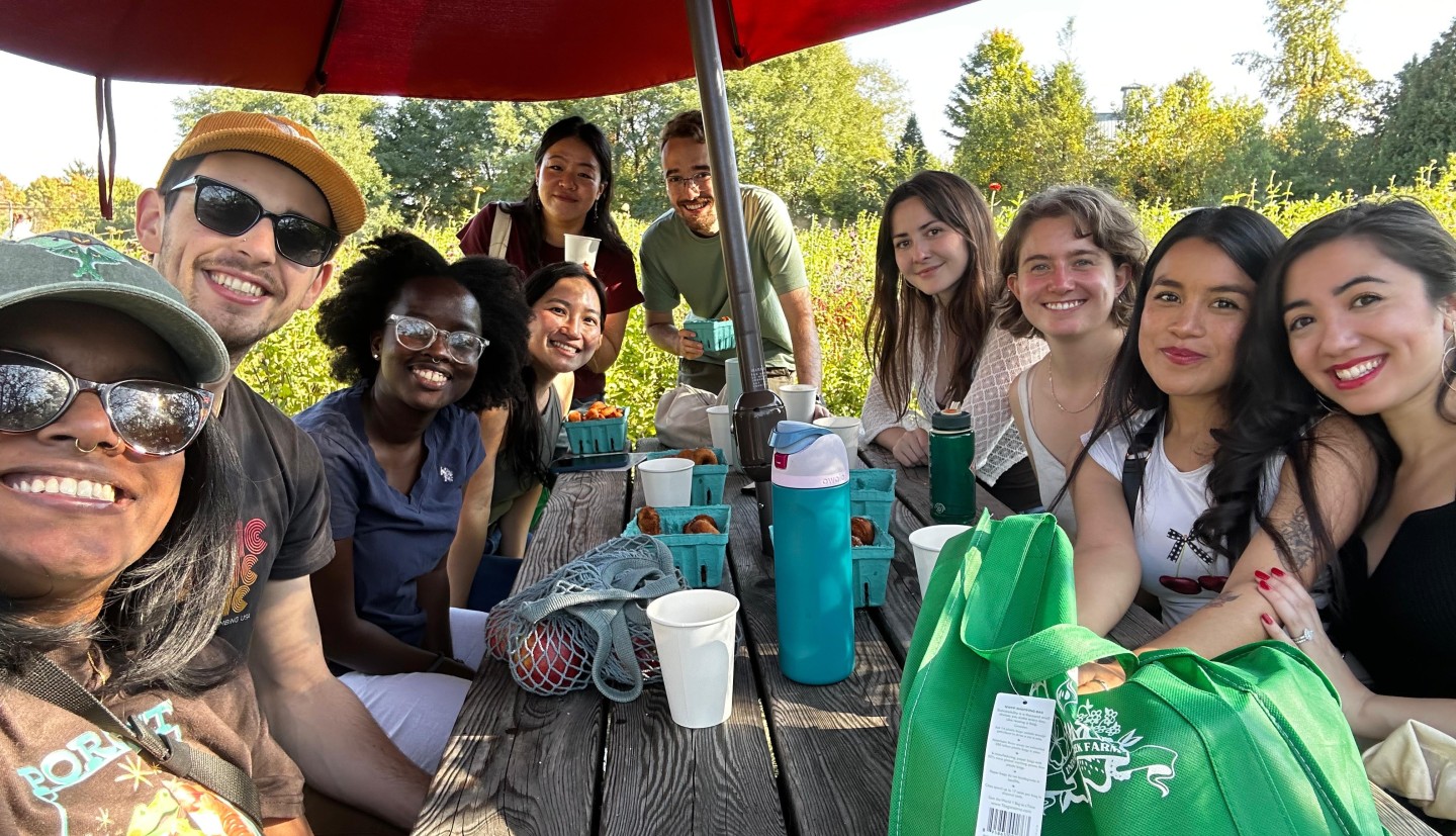 people sit around picnic table at farm
