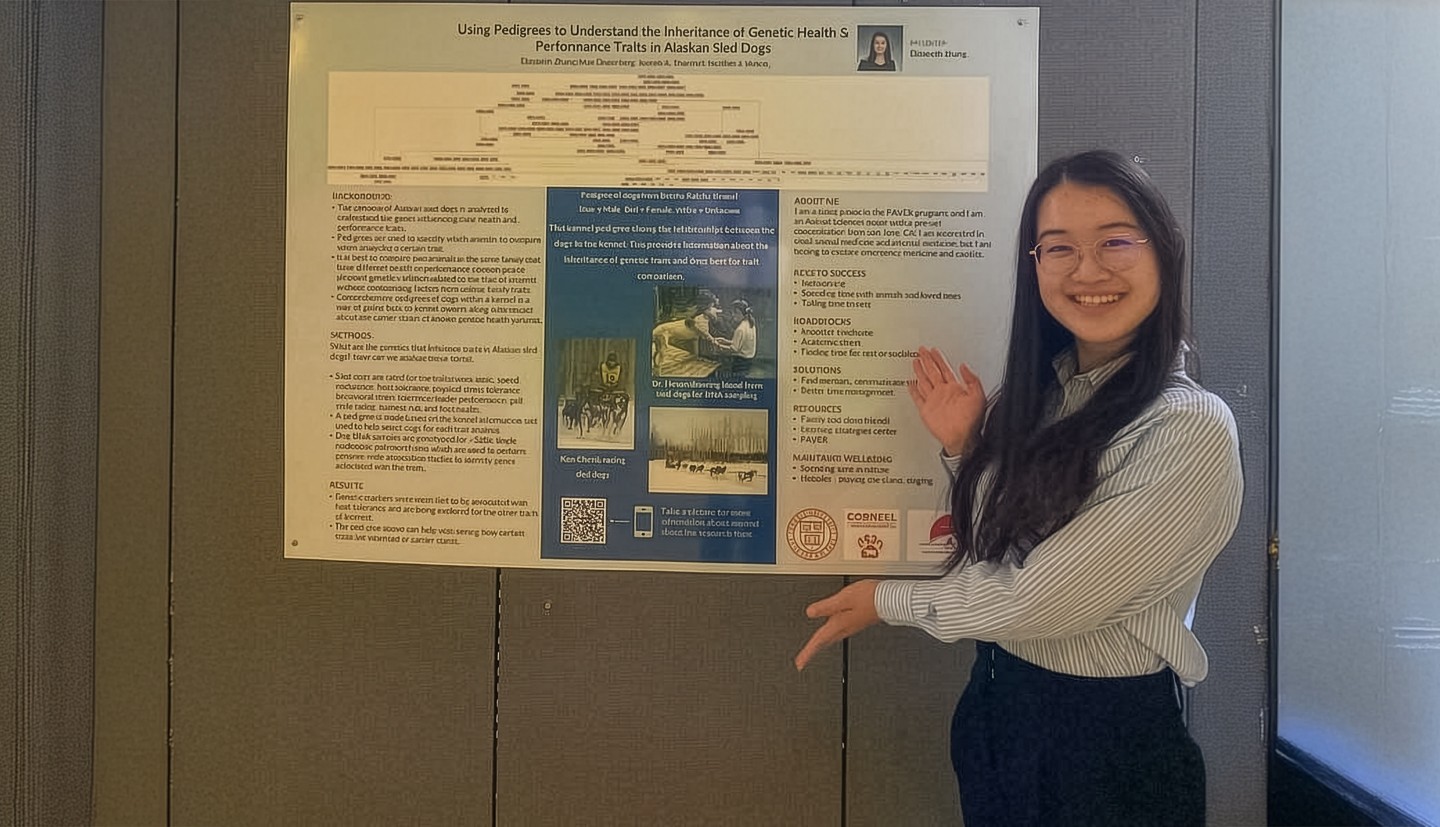 a woman stands in front of an academic poster