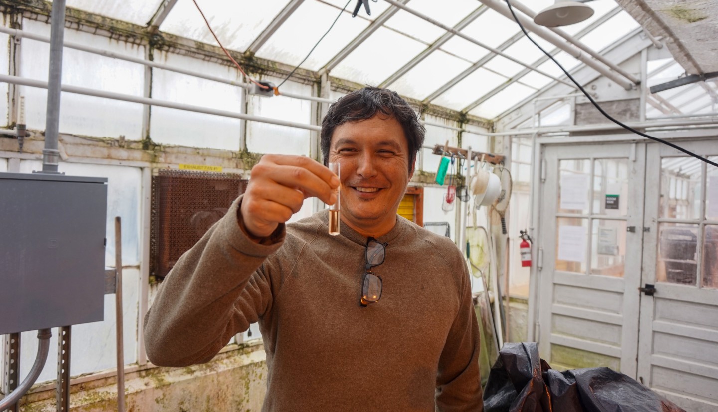 a man holds a vial of liquid