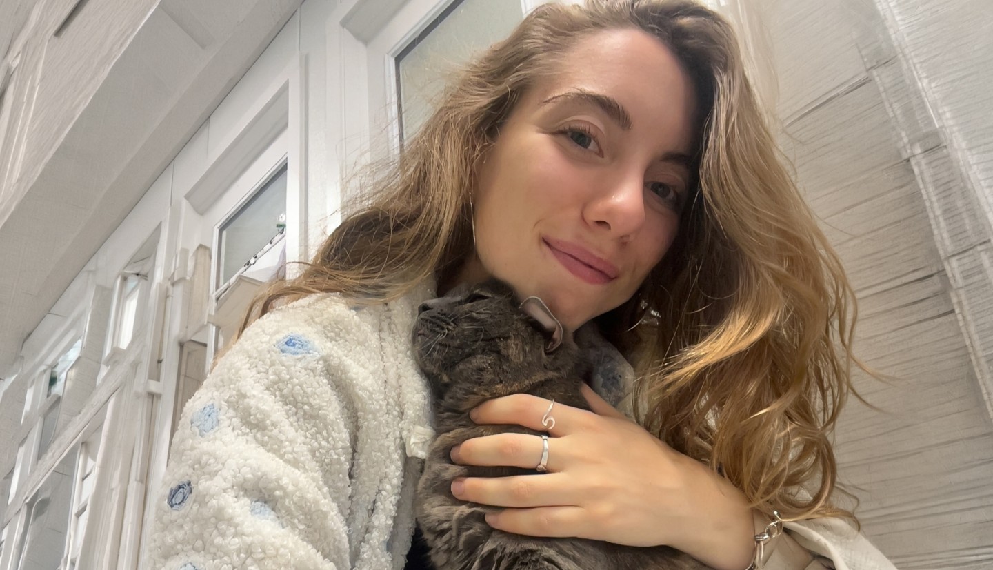 a woman hugs a cat