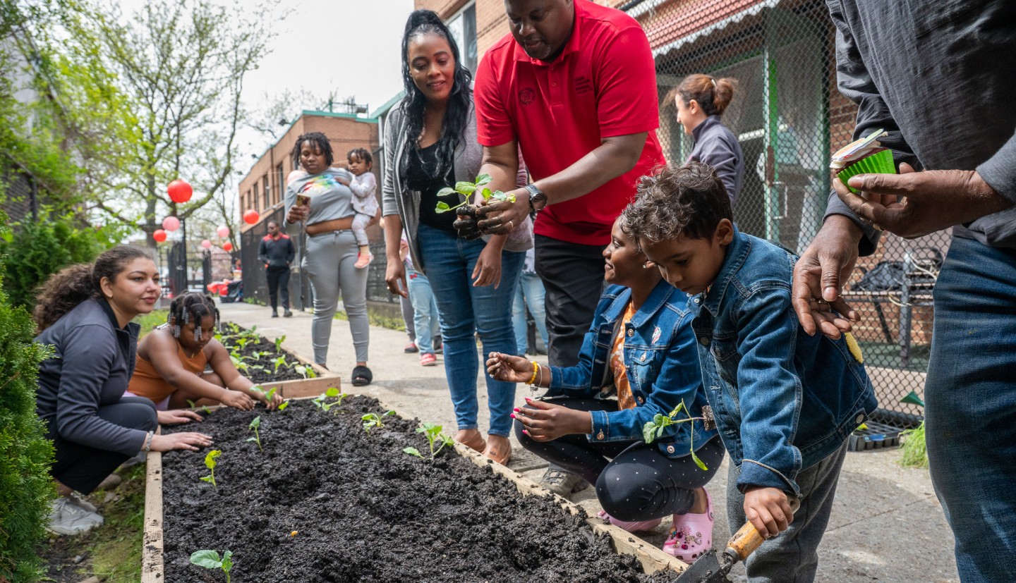 Kwesi at a community garden in Queens talking about soil with youth